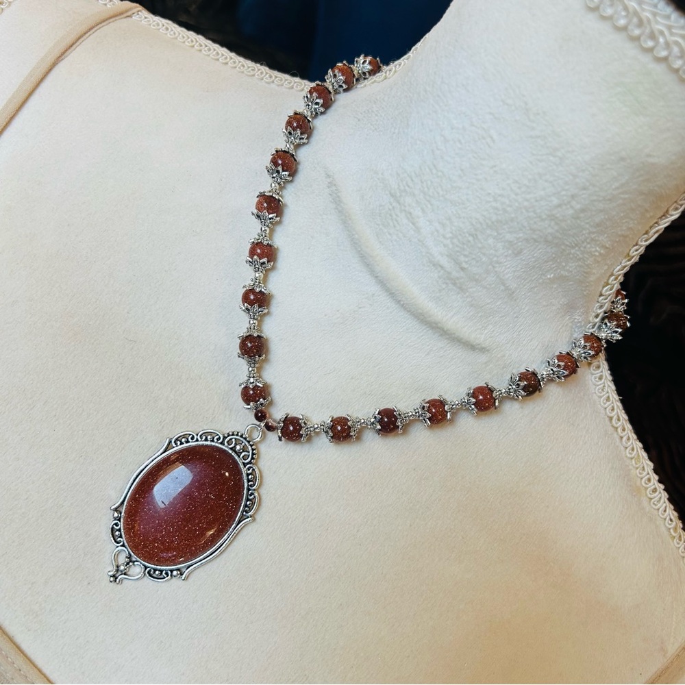 Handcrafted elegant goldstone cameo framed bead necklace